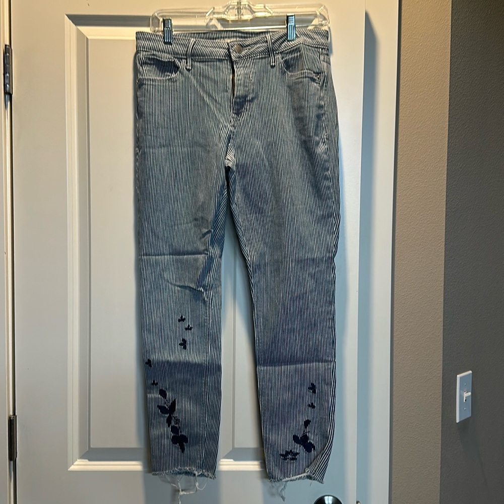 Cute Old Navy jeans in size 10 with embroidered butterflies at bottom of legs.